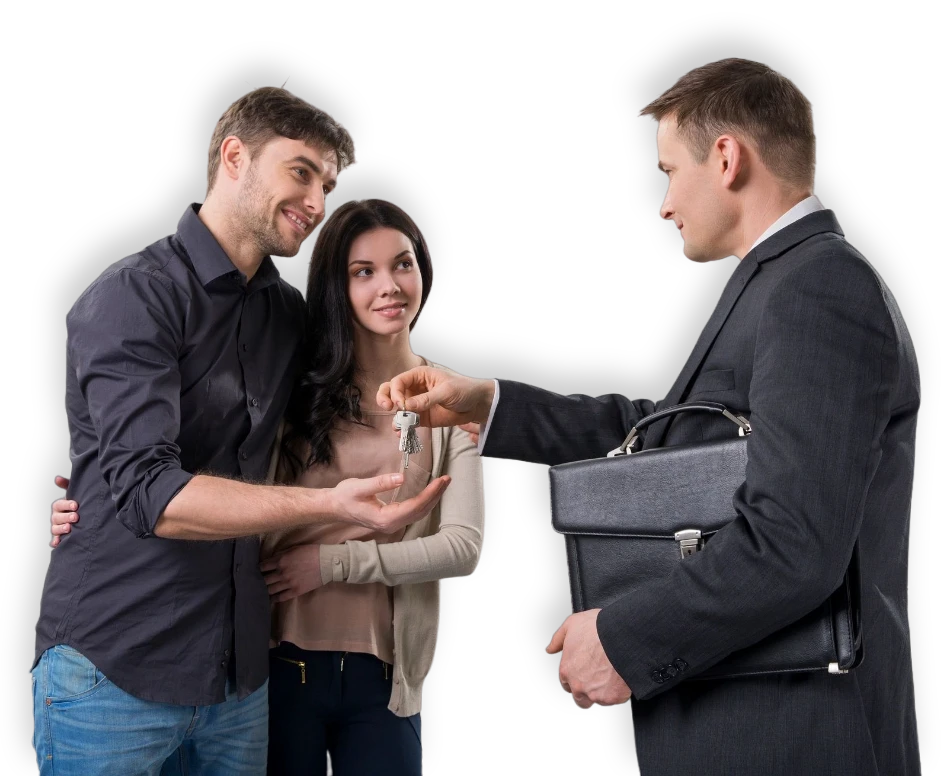 A man handing keys to two women.